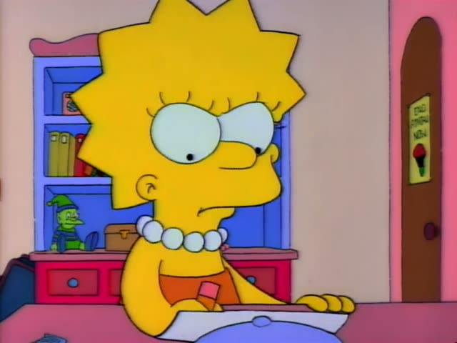 Lisa Simpson sits at a pink table with a sheet of stationery and a pen, writing a letter in her bedroom