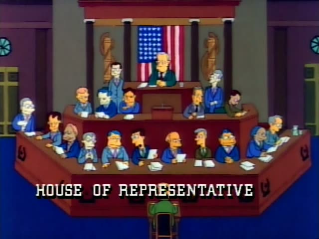 A group of identical-looking politicians sits at tiered wooden desks in the House of Representatives chamber…