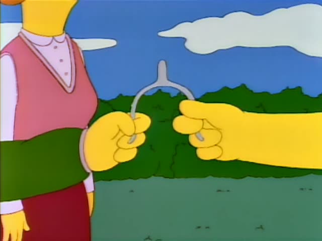 Homer Simpson, Ned Flanders in his green sweater and moustache, and a woman with curly orange hair in a pink top stand…