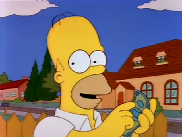 Homer Simpson stands outside in a suburban yard, holding a folded banknote in one hand and gesturing with his other hand…