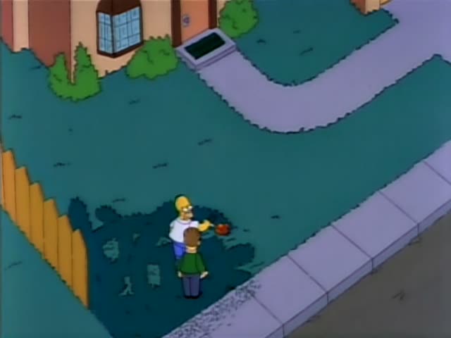 Homer Simpson and Ned Flanders stand on a lawn beside a sidewalk and a wooden fence in front of a brick house