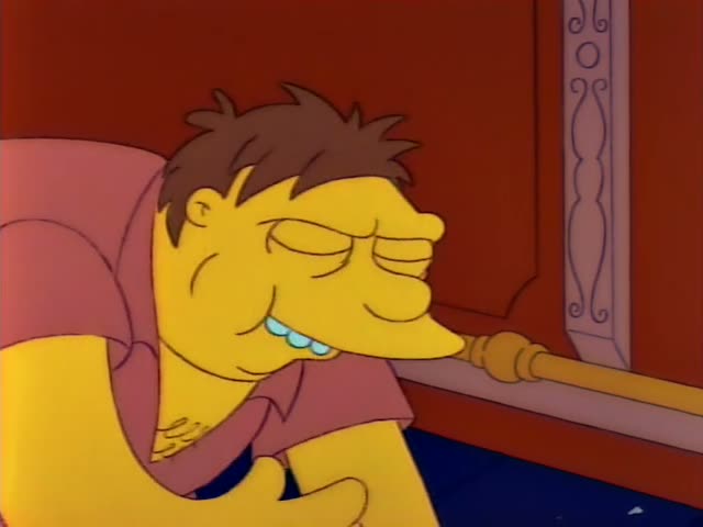 A brown-haired, thin cartoon man in a pink shirt with a tattoo on his chest, eyes closed and grinning with buck teeth, leans…