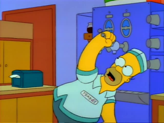 Homer cranks a valve on a blue machine while Apu glances sideways beside him