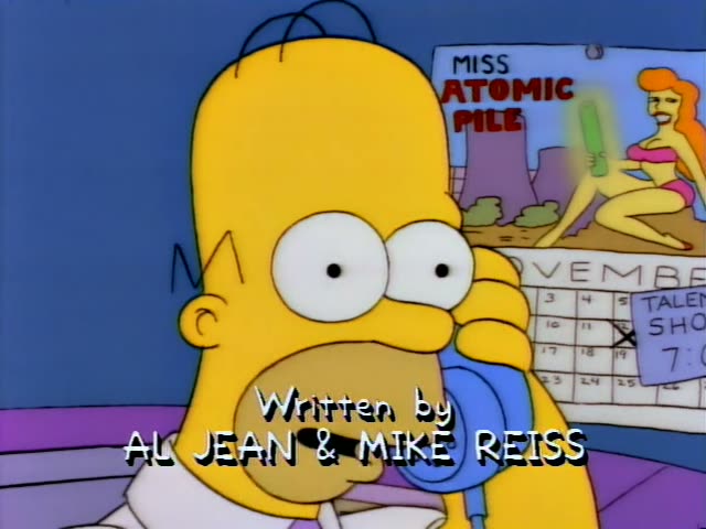 Homer Simpson sits with a blue phone to his ear beside a wall calendar showing a Miss Atomic Pile poster and a November page…