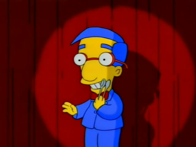 Milhouse stands in a red spotlight against a dark red curtain, holding two spoons