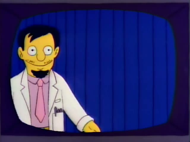 A goateed man in a white lab coat, pink shirt and pink tie, presumably Dr. Nick Riviera, stands against a blue curtained…