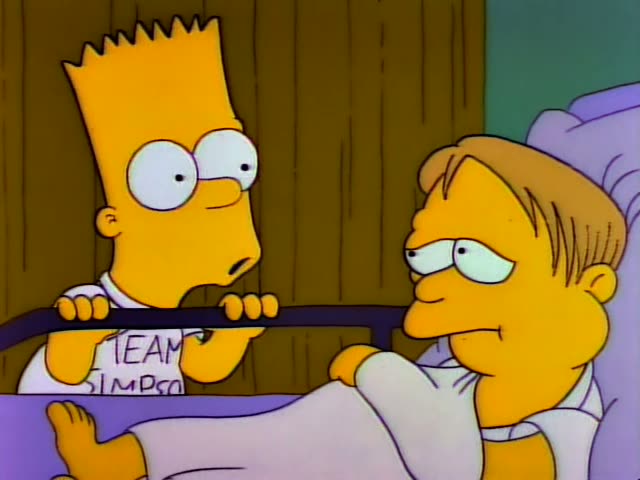 Bart grips the purple bed rail beside a one-off patient with short light brown hair and a white nightshirt lying in bed…