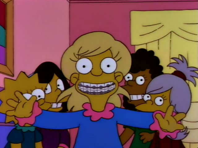 Bart stands in a purple kitchen with a stove and cabinets as a grey-haired woman with gritted teeth looks on from the left…