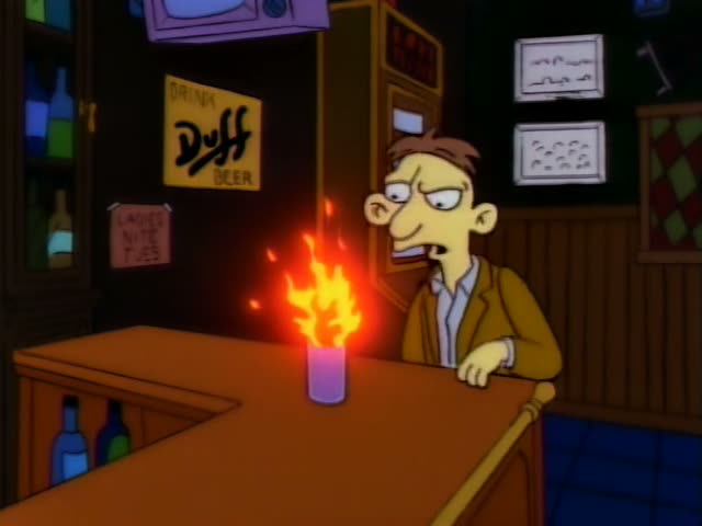 A slim, brown-haired man in a tan jacket sits at a bar under a Duff Beer sign and a Ladies Nite Tues poster, first glaring…