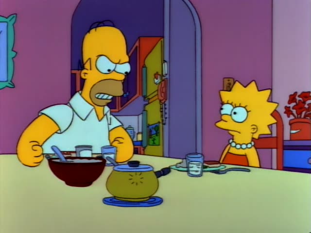 Homer Simpson sits at the kitchen table in the first frames, scowling and gritting his teeth beside a bowl and a saucepan…