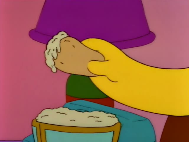 Homer sits in a brown armchair beside a purple lamp and a side table with a bowl of dip, while Marge stands near a red door