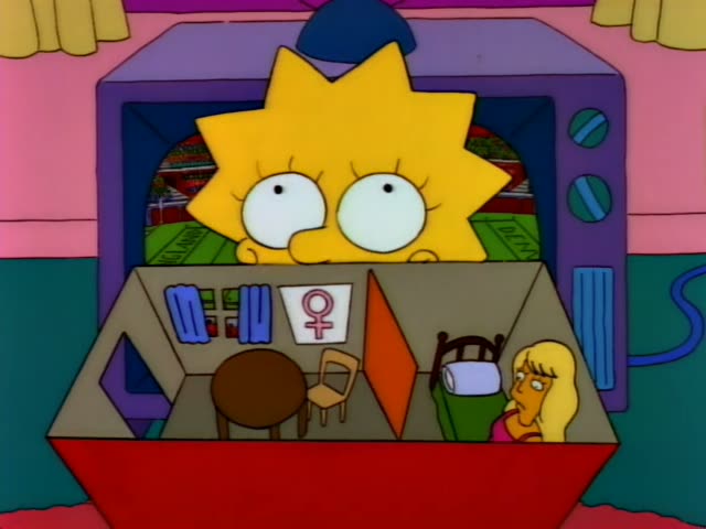 Lisa first peers over a TV set at a cardboard dollhouse where a blonde doll sits beside a tiny table and chair