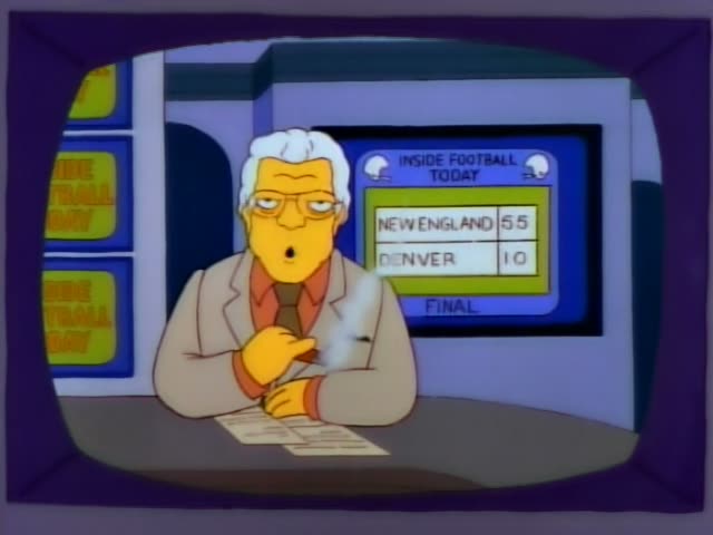 Kent Brockman sits at a desk with papers, holding a pen and speaking while a monitor behind him reads INSIDE FOOTBALL TODAY…