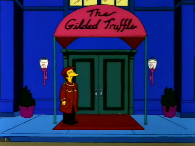 A doorman in a red uniform stands outside The Gilded Truffle beneath its pink awning sign, with potted plants on either side…
