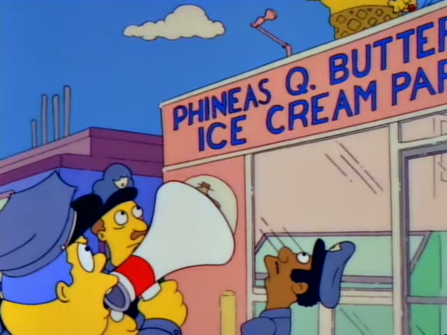 Chief Wiggum raises a white megaphone toward Phineas Q. Butterfat's Ice Cream Parlor while other officers stand beside him…