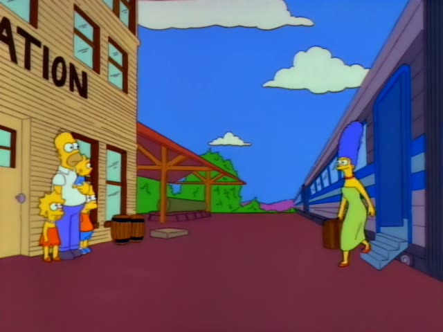 Homer, Lisa, Bart and Maggie stand outside a building with a STATION sign while Marge walks toward them along the platform…