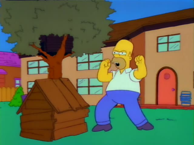 Homer Simpson stands on a grassy lawn in front of the Simpson house with its red arched door and a blue recycling-style bin…