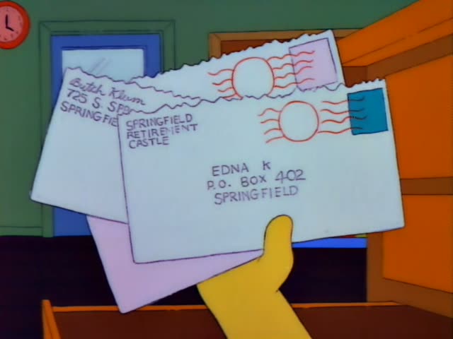 Bart Simpson leans over a wooden desk holding a stack of envelopes addressed to Edna K, P.O. Box 402, Springfield…
