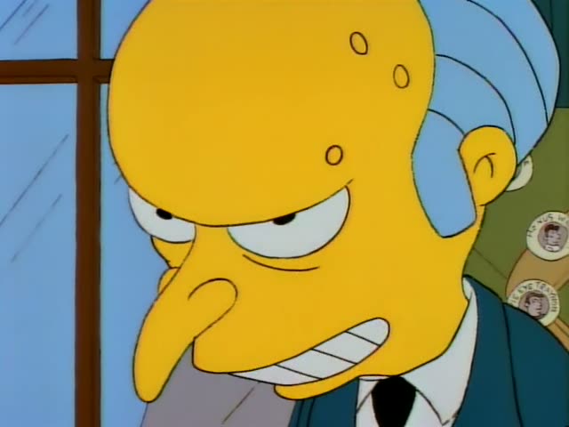 Mr. Burns scowls in a close-up at first, his mouth open as he speaks, then stands beside a window in a dark suit