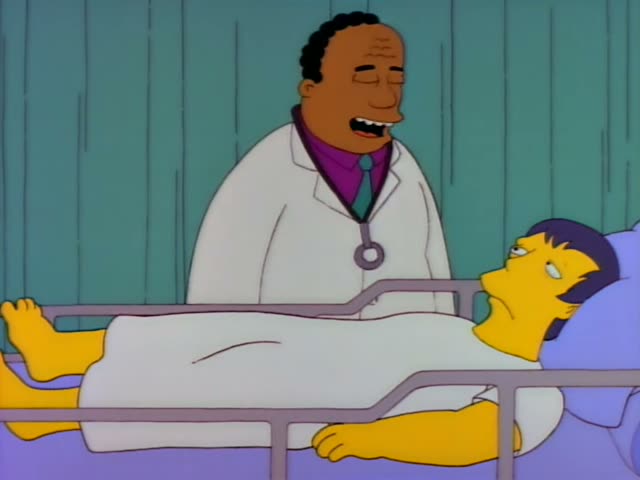 Dr. Hibbert stands beside a hospital bed in a teal-walled room while a patient with short dark hair lies under a white sheet