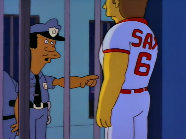 A police officer with a moustache and cap, pointing through the bars of a cell, faces a baseball player in a white Sax…