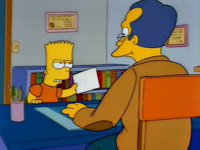 Bart stands at a blue desk beside a bookshelf and holds up a white paper with a scowl, then grins and gestures with it…