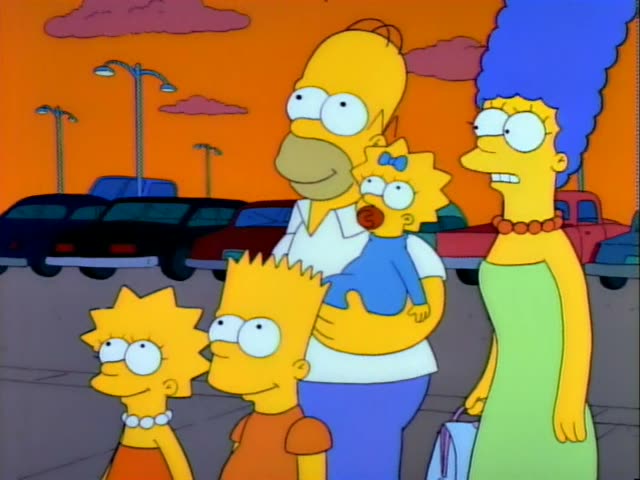 Homer, Marge, Lisa, Bart and baby Maggie stand together on a parking lot under an orange sky with rows of parked cars…