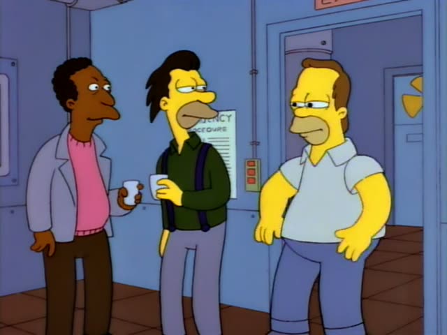 Carl stands with Lenny, who has spiky black hair, a green sweater and suspenders, both holding white mugs…