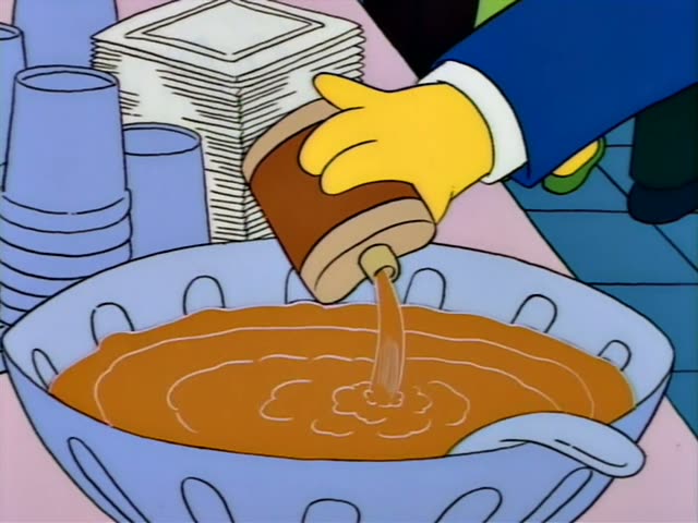 Homer and Marge stand behind a light-blue punch bowl at a campus party while a hand in a blue sleeve pours brown liquid…