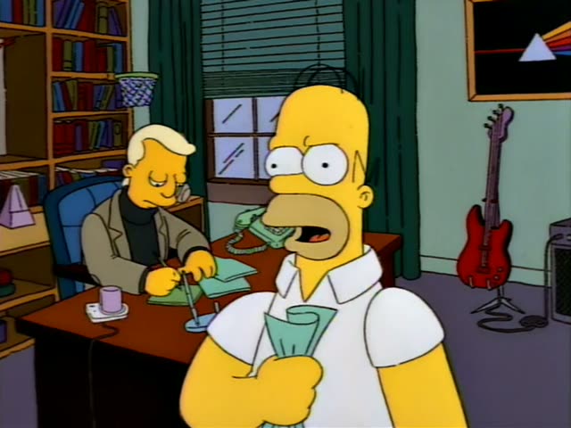 Homer stands in the foreground holding a green paper cup while a blond man in a grey jacket and black turtleneck sits…