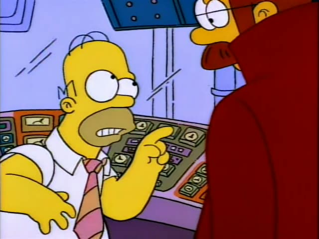 Homer and Flanders in a red cape with a moustache, glasses and a blue beaded necklace stand together in a control room lined…