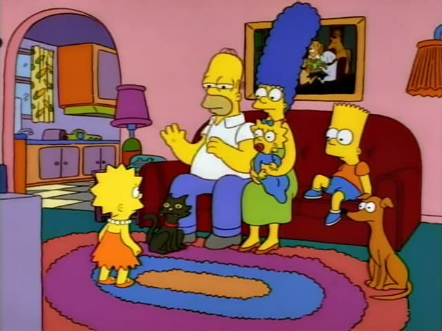 Homer, Marge, Bart, Lisa, Maggie, Santa's Little Helper and Snowball II sit or stand in the pink living room, with Homer…