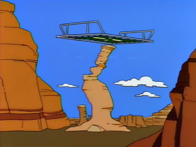Homer stands on the edge of a sandstone cliff against a bright blue sky, first with his hands clasped at his chest and later…