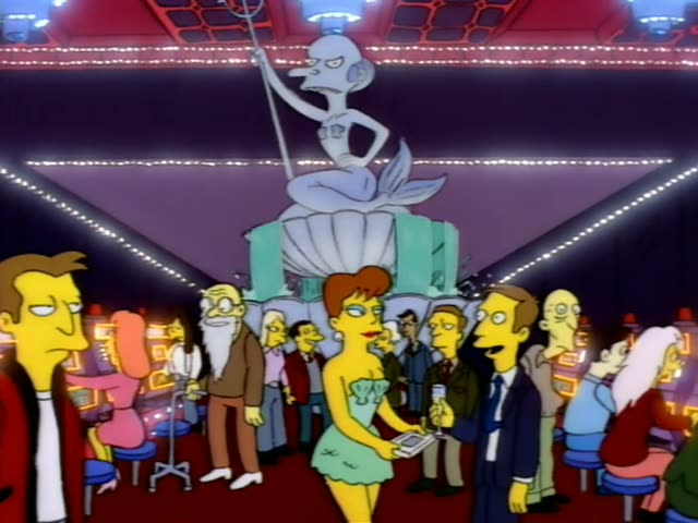 Homer works as a casino dealer at a green felt table lined with red and blue chips, with slot machines behind him