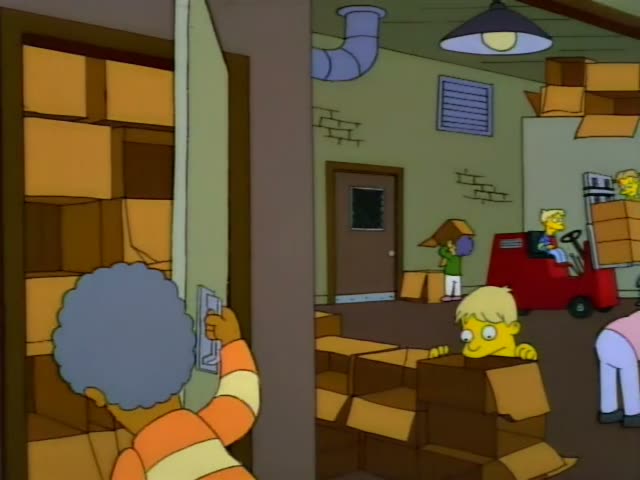 Principal Skinner grips the shoulder of Mrs. Krabappel, who has a tall brown hairdo and wears a green sweater, as she…