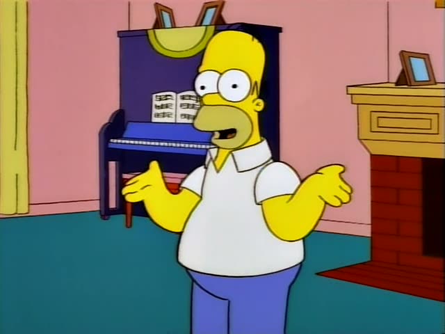 Homer stands in front of a blue upright piano and a brick fireplace in a pink room, gesturing with open hands…