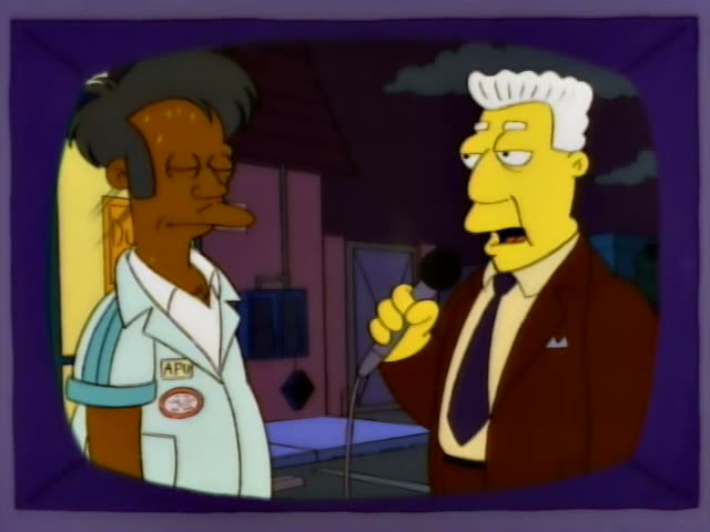 Apu stands beside Kent Brockman, the grey-haired news anchor in a brown suit and purple tie, who holds a microphone…