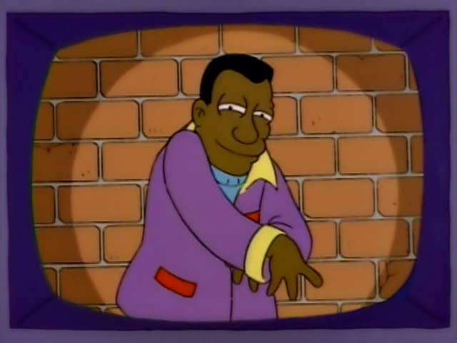 Carl stands against a brick wall framed by a TV-style border