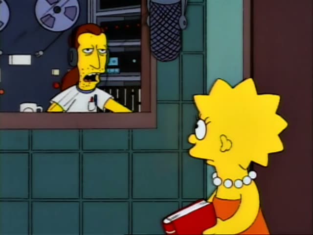 Lisa Simpson stands beside Krusty, a clown with green hair, a white cap and a pink shirt, outside a recording booth…