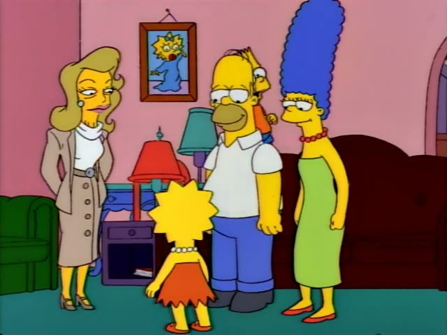 Lisa stands in the center of the pink living room in her red dress, with Homer and Marge beside her and a blonde woman…