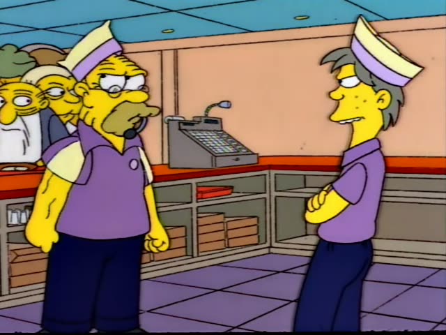 Two employees in purple Kwik-E-Mart uniforms and paper hats stand on a purple tiled floor in the store