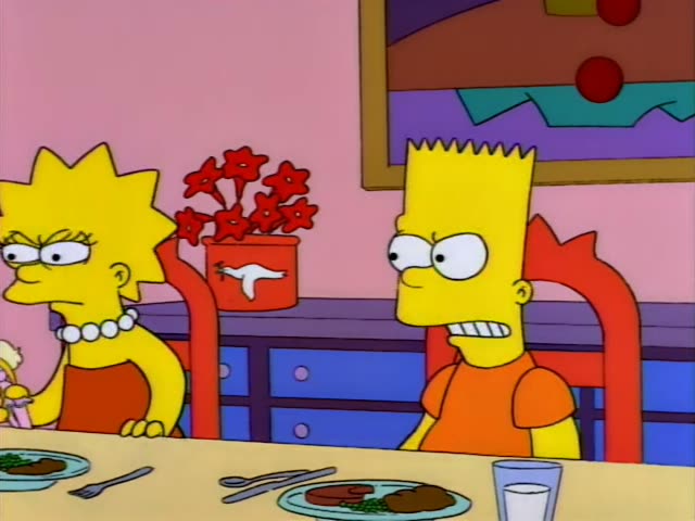 Lisa and Bart sit scowling at a dinner table set with plates, a fork and a glass of milk beside a red flowerpot…
