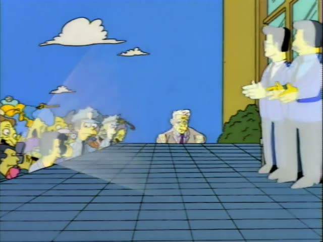 A crowd of cartoon townspeople gathers outdoors at a grand opening event under a banner…