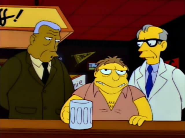 Barney sits at the bar with a glass mug in front of him while a grey-haired man in a dark suit and tie stands at his left…