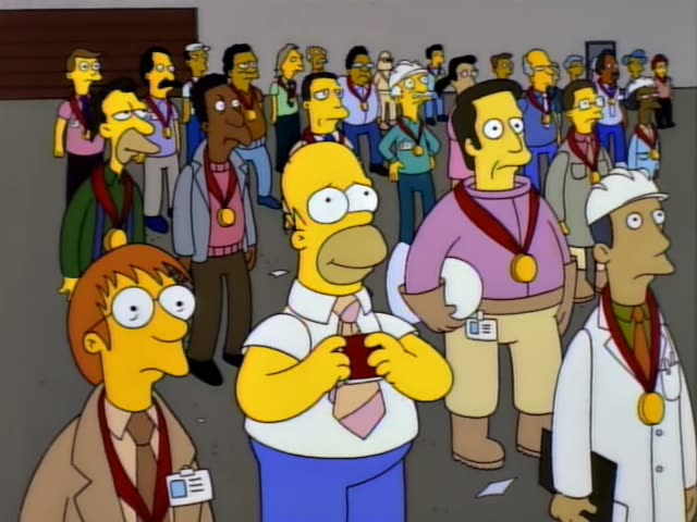 Homer stands in a crowd of medal-wearing people in a white shirt, blue pants and pink tie, holding a red-ribboned medal…