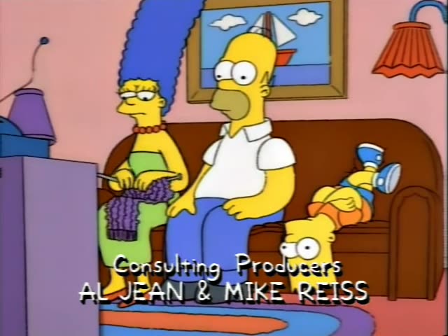 Marge Simpson knits a purple scarf on the left while Homer sits in the middle of a brown couch in his white shirt and blue…