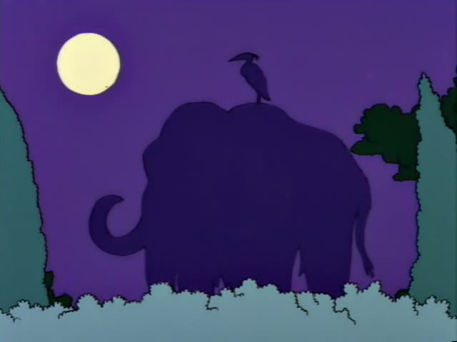 Bart Simpson runs past dark hedges at night and then stands staring up at a pale blue sculpture of a mammoth on a brown…