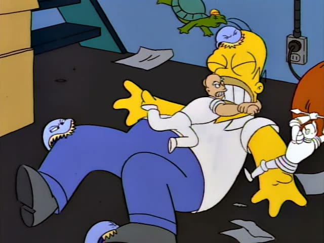 Homer lies sprawled on a dark floor among scattered papers while several blue-skinned, blue-clad creatures with yellow fur…
