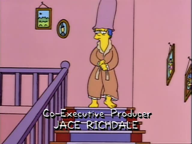 Marge stands on the staircase in the pink house, then walks down, stepping onto a squashed sandwich that leaves red…
