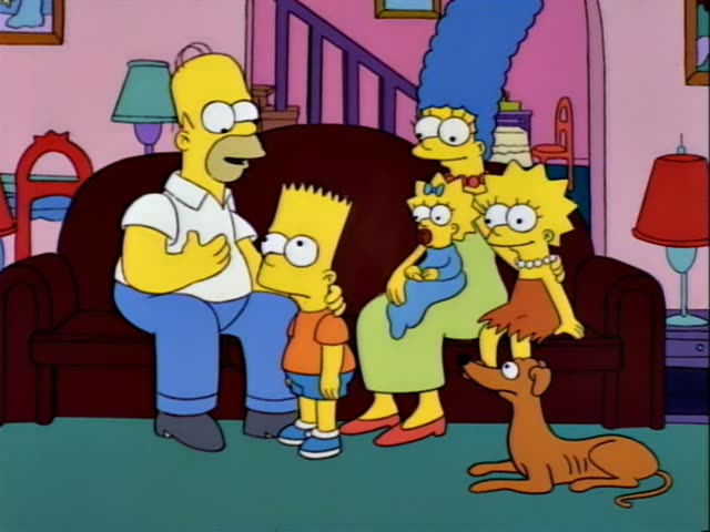 Homer sits on the left end of a dark red couch in the family living room with pink walls, lamps and a staircase behind him…